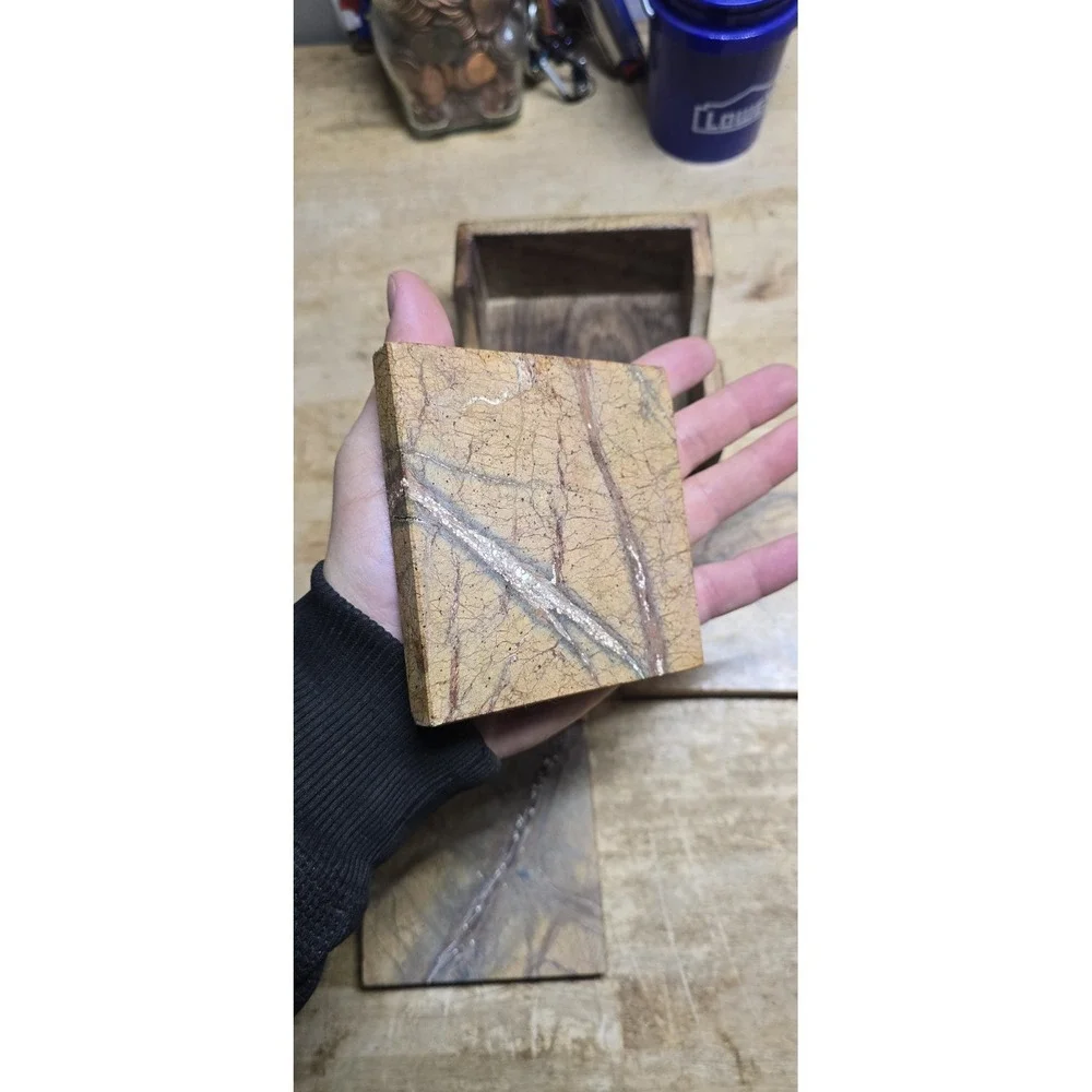 square marble coaster set holder in a wooden base.